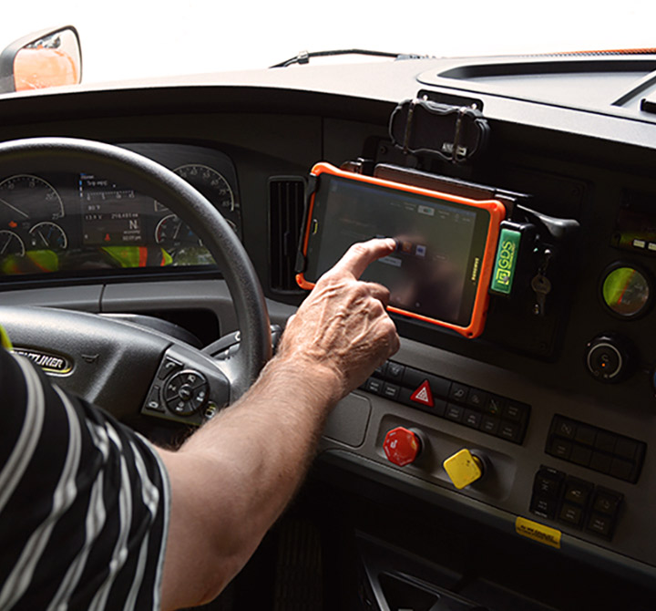 Truck driver using smart tablet monitoring system. 