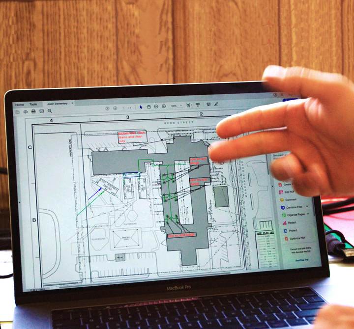 MacBook Pro laptop screen showing blueprints.