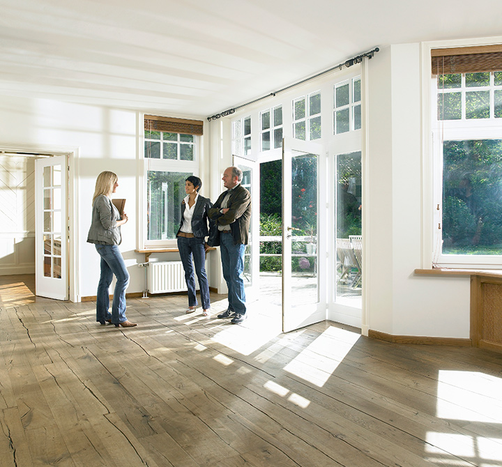 Three people touring empty house from Atlanta Fine Homes.