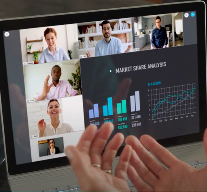 Laptop screen showing a video conference and Market Share Analysis powerpoint slide.