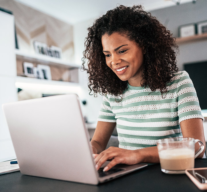 Female remote worker at home on laptop.