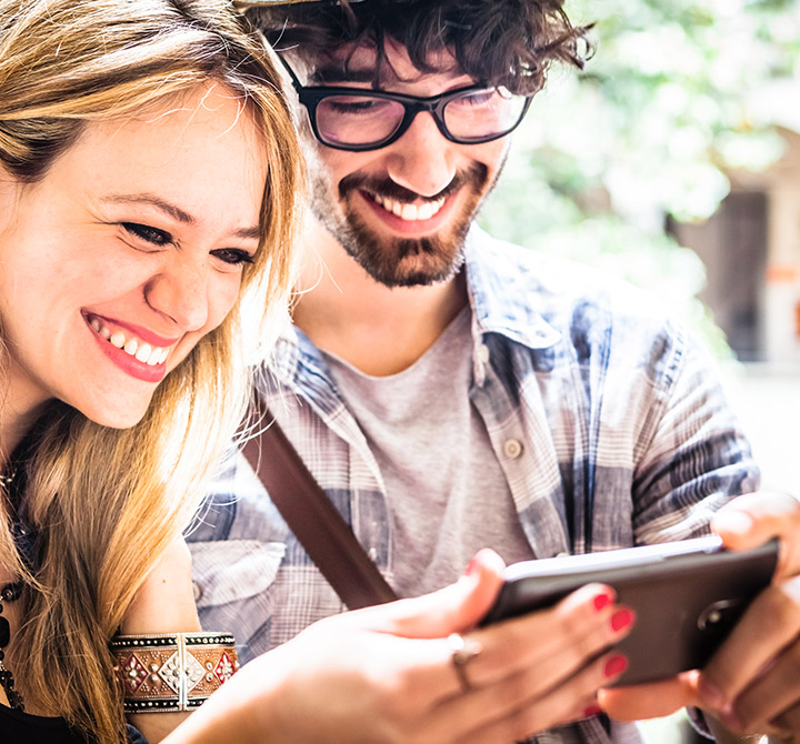 Man and woman smiling taking a selfie.