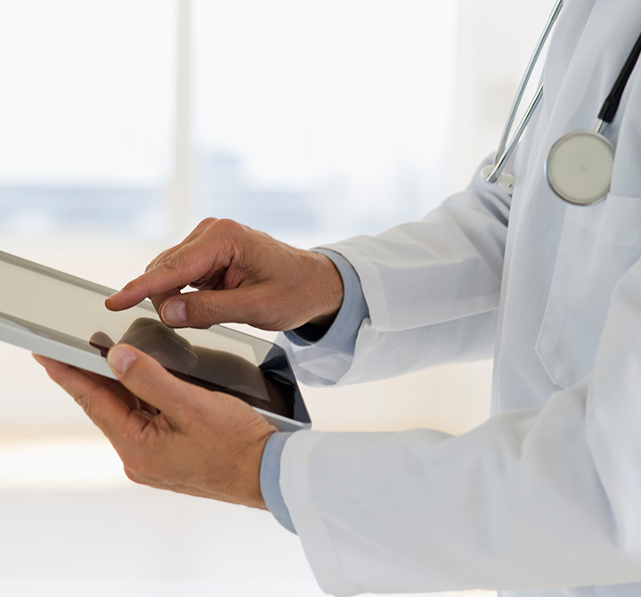 Zoomed in image of doctor holding a tablet.