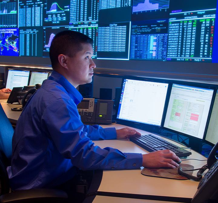 Man working at computer in security operations center.