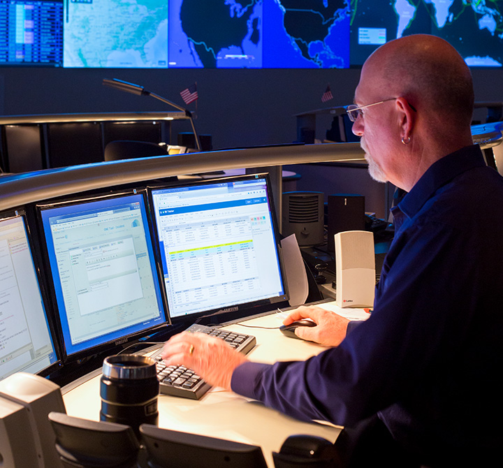 Man working at computer in security operations center.