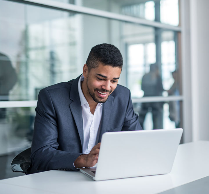 Man working at laptop in office.