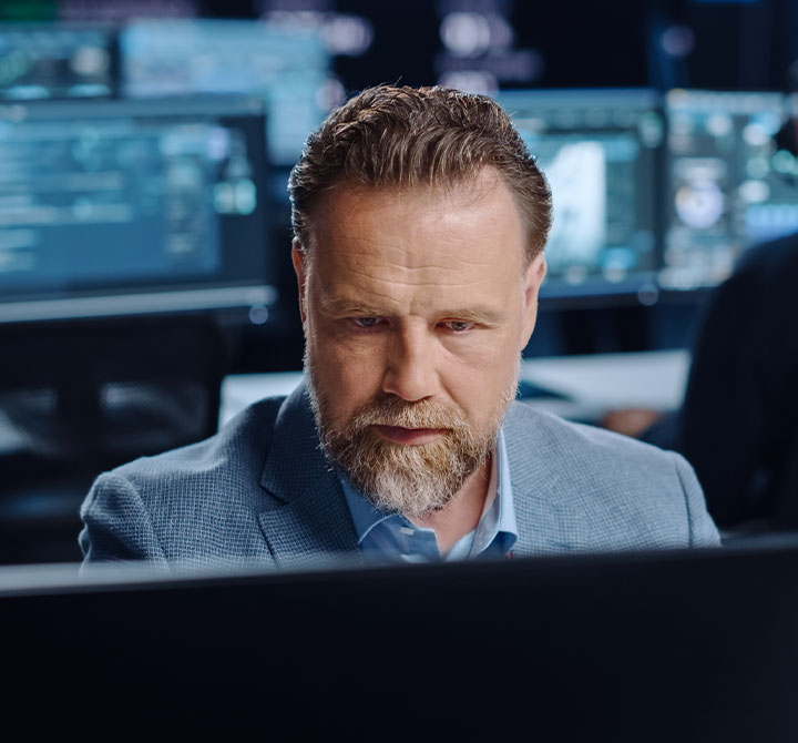 Man working on computer in office.