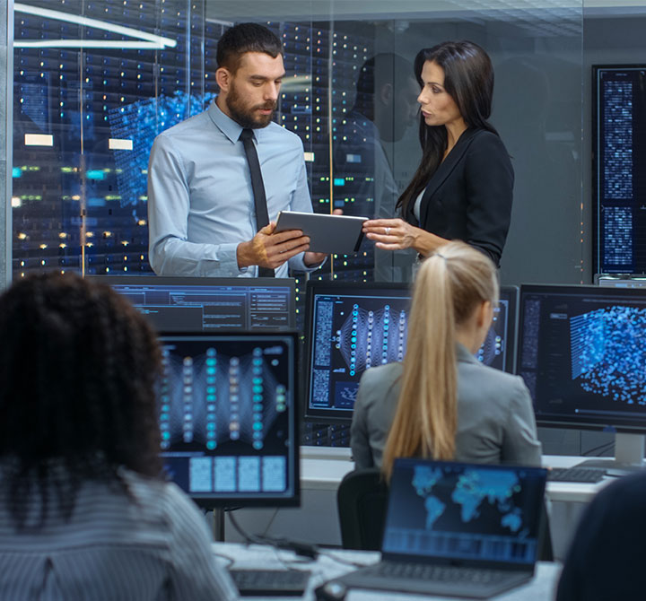 Man and woman having a discussion in the Security Operations Center.