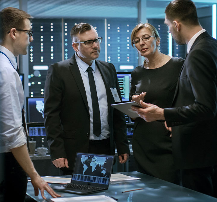 Group of people having a discussion in a Security Operations Center.