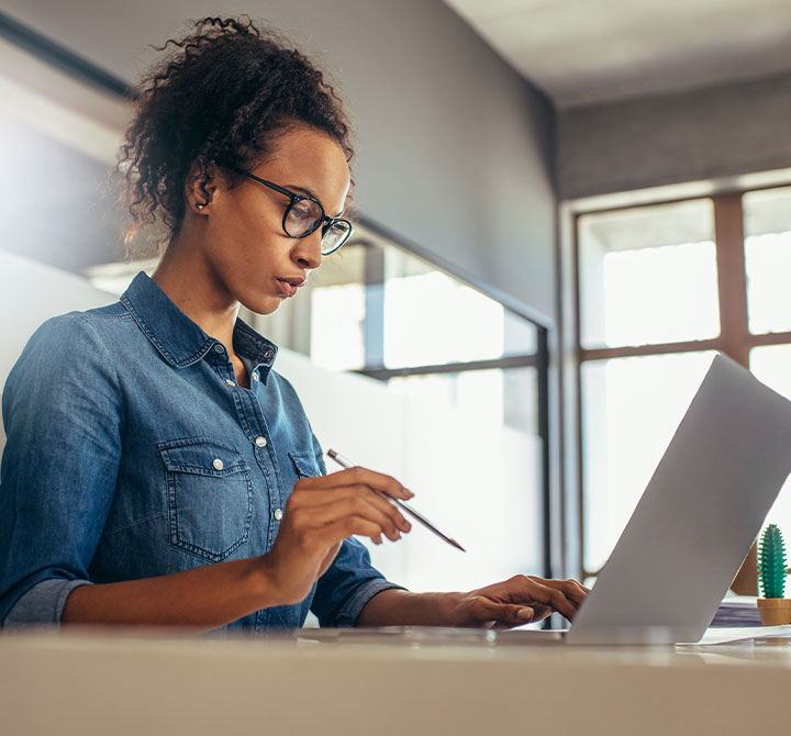 Woman working on laptop.