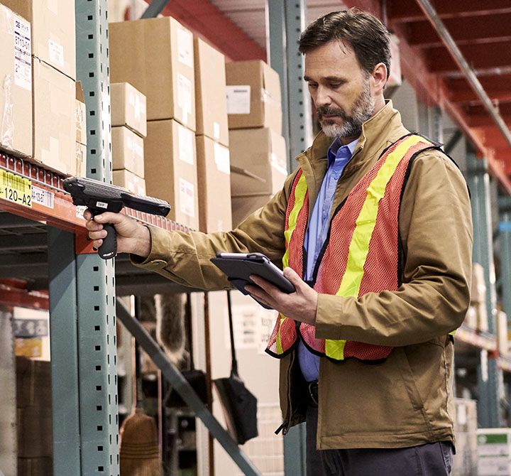 A warehouse worker scanning an item.