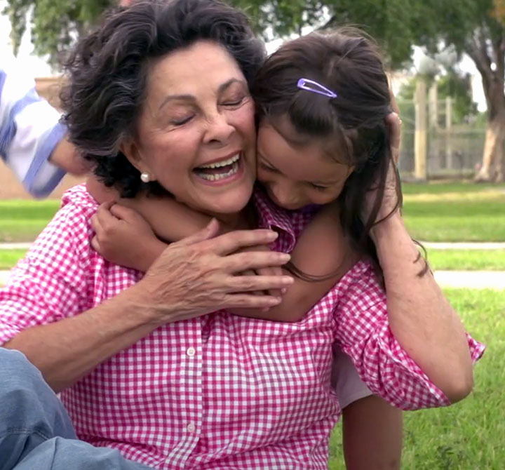 Elder receiving a hug from a small child