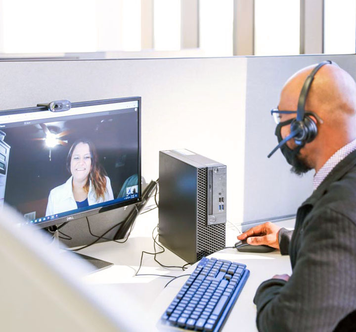 office associate on virtual call in an office cubicle