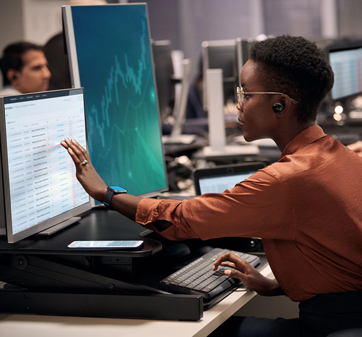 Insurance professional viewing data on computer monitor