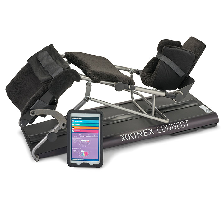 A view of a KinexConnect CPM machine with a tablet device displaying the Rehab Status Dashboard application.