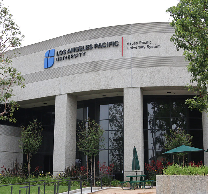 Exterior view of a Los Angeles Pacific University building - a grey building with the school name and logo on the top left.
