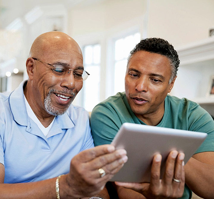 Two men looking at a tablet