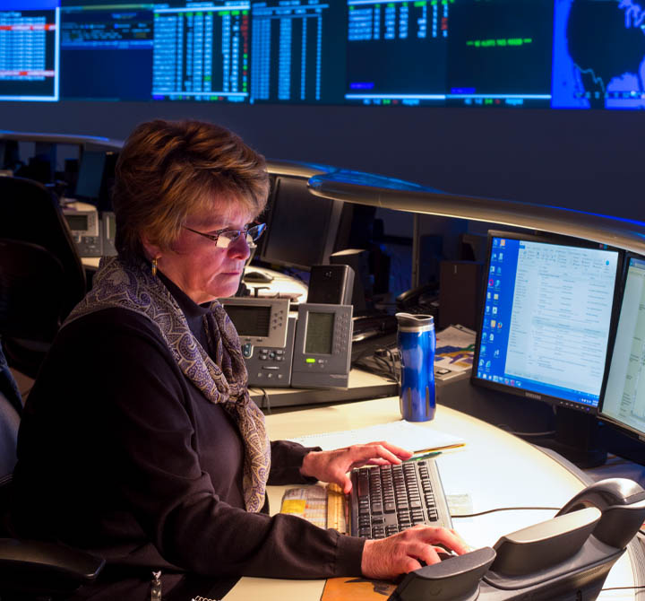 Woman working at computer in security operations center.