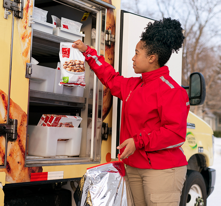Schwan delivery driver taking products out of a delivery van