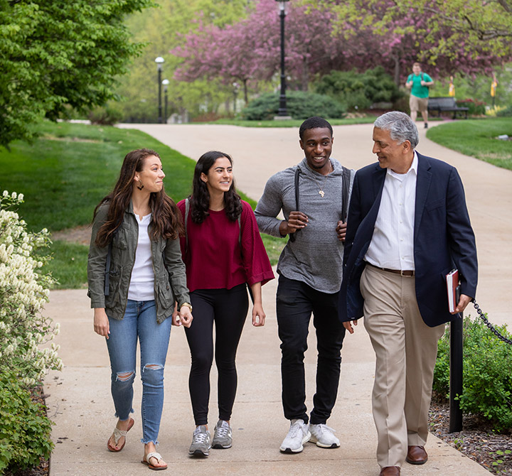 Students walking with professor on University of Missouri campus