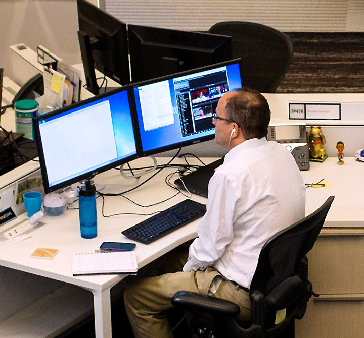Man at a computer work station in the WaPo bullpen