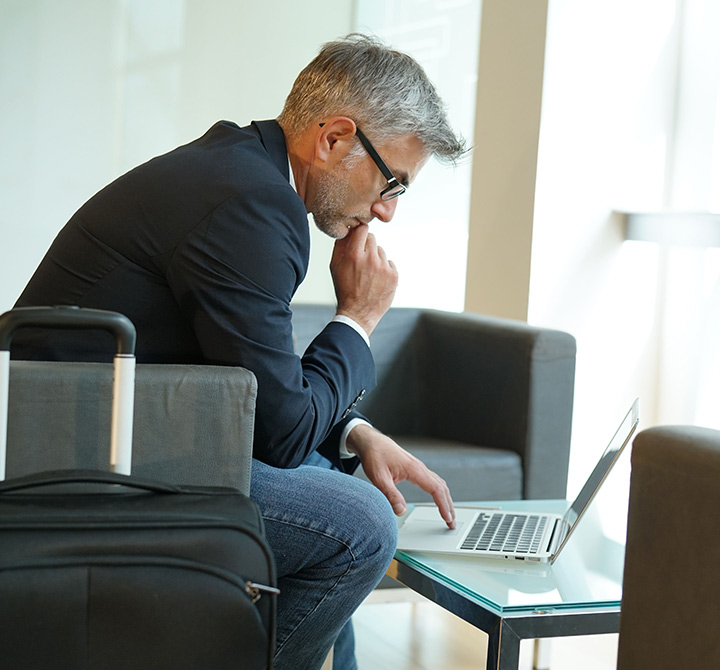 Businessman using laptop in a public location