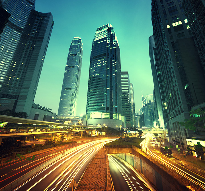 City at night with blurred vehicle lights on roadways.