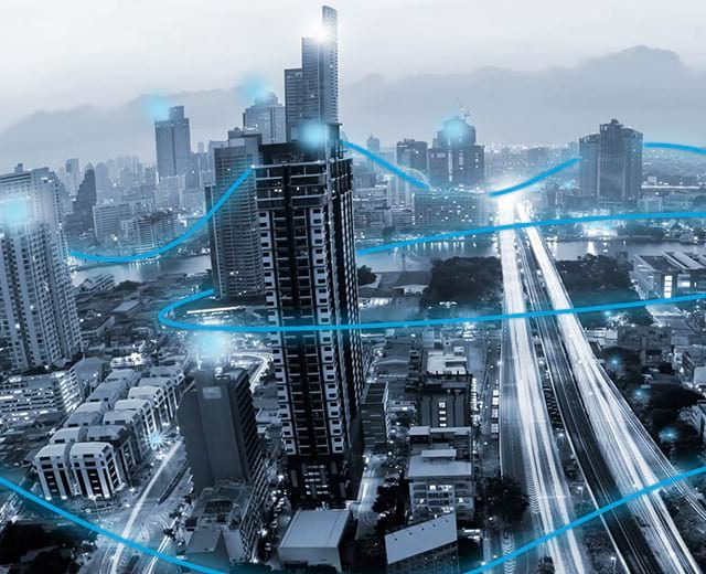 Cityscape with blue digital connection paths weaving through the buildings
