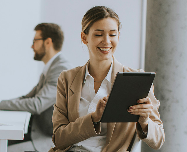 Woman on tablet using self service support portal in office setting