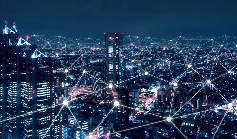 Cityscape showing networking connection points at night.