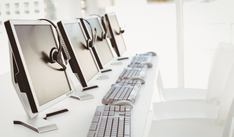 Call center computers and headsets all in a row