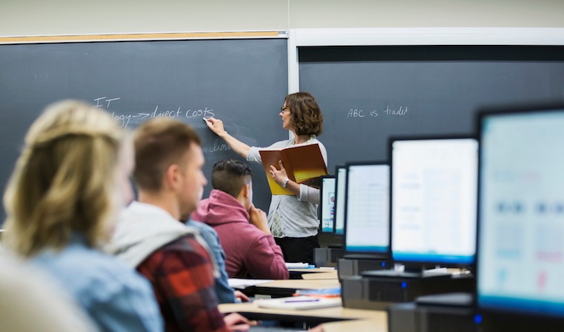 Professor leading lesson in computer lab classroom