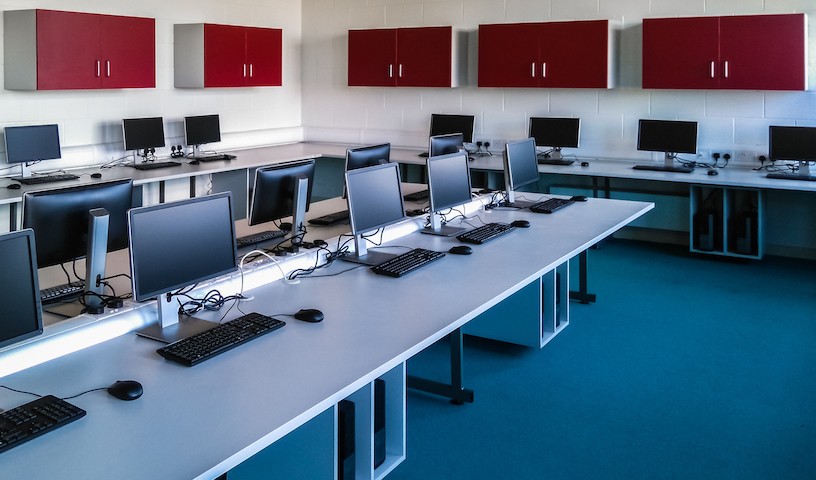 Room with computers in a row.