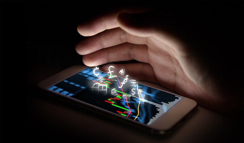 Currencies sign icon and smartphone with stock market graph screen and finger with black background. Blockchain , Fintech Investment Financial Internet Technology Concept.