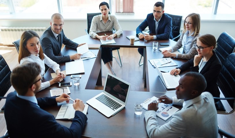 Businespeople at panel discussion in board room