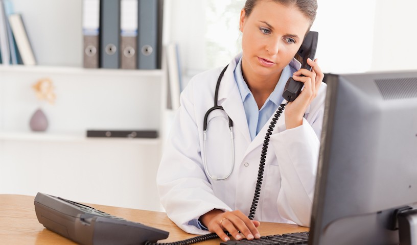 Serious doctor on the phone in her office