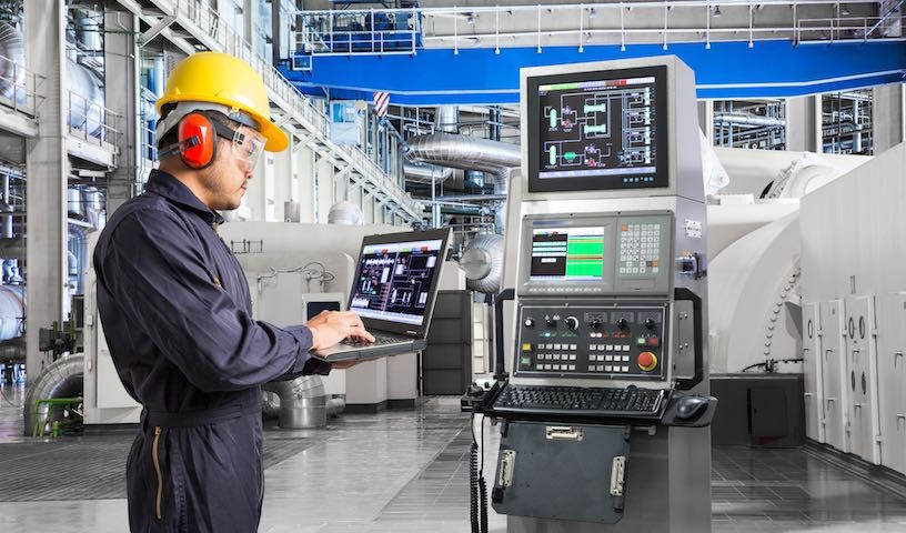 Engineer using computer for maintenance equipment in thermal power plant factory