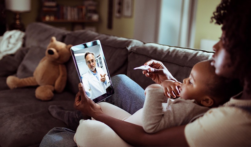 Mom and child on tablet telehealth doctor appointment