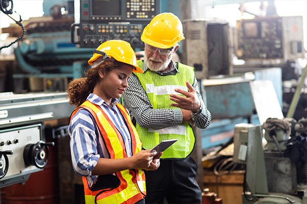 Manufacturers looking at tablet in work area