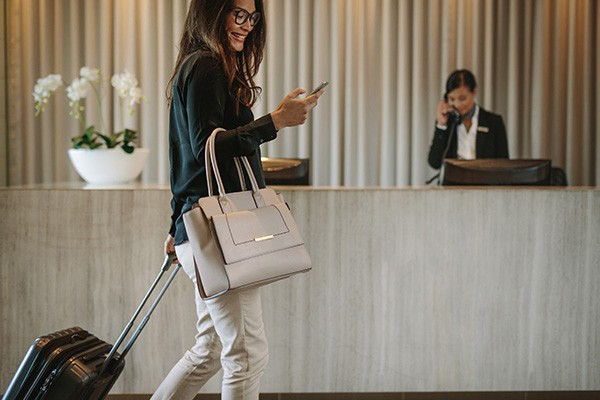 Woman in hotel lobby completing a mobile check-in