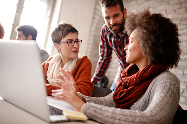 Small business workers in front of a laptop