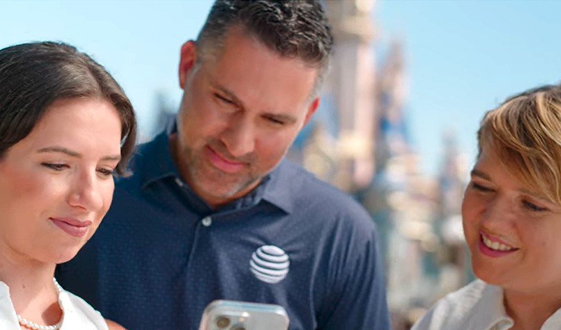 AT&T associates using a smartphone at a Disney park