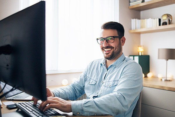 Man working from home on a desktop monitor