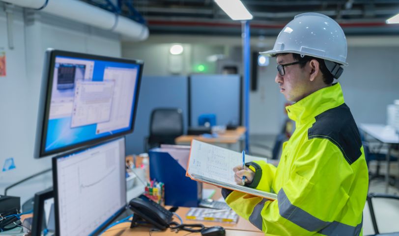 Inside the large Industry Factory Female Computer Engineer Works on Personal Computer She coding program for control machine,Thailand people work on fours monitors,Programmer working with serious