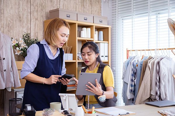 Asian young adult tailor clothing fashion fabric in small business, customer consult pattern order service communication, young entrepreneur providing professional design advice, lifestyle branding