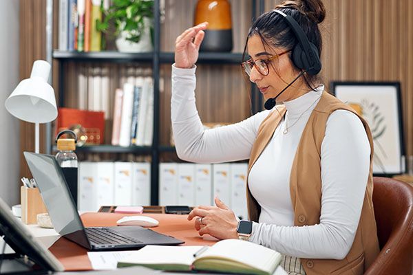 Headset, talking and woman with laptop in office for call center, crm or online consultation. Mic, explaining and virtual assistant on computer with query for customer service, help desk or support