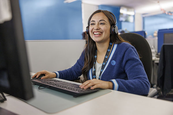 AT&T agent sitting at desk on a call