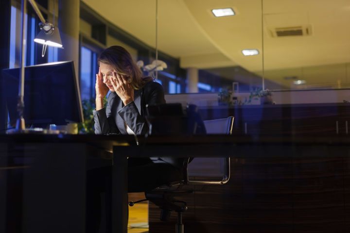 Mature businesswoman working late at her desk.