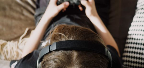 Woman wearing headset and playing online game