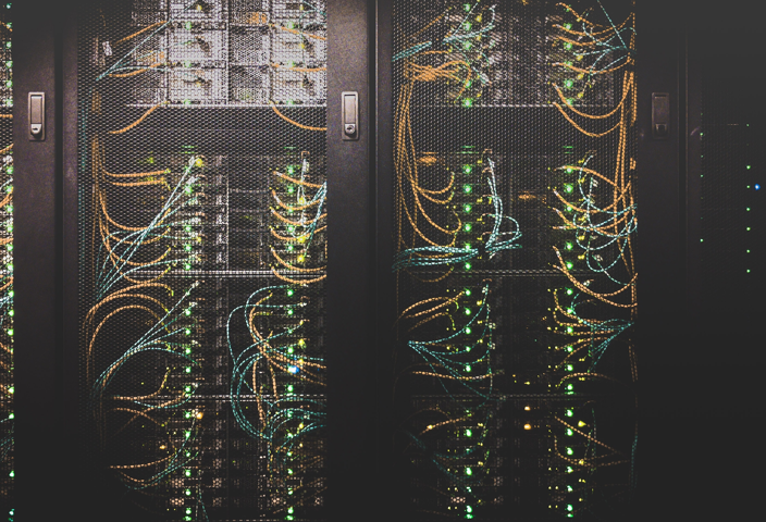 Servers stacked in racks connected with wires